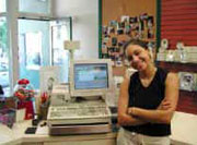 Employee at check out with computer register