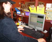 Traditions employee working the CRE register